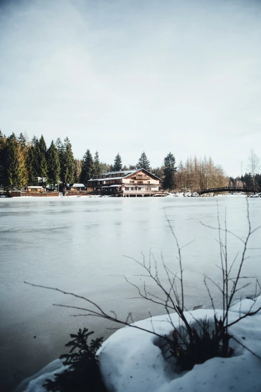 a snow covered lake with many homes in the distance