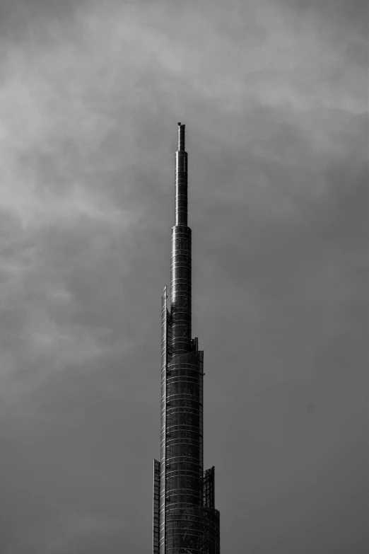 a tall tower is in the middle of black and white