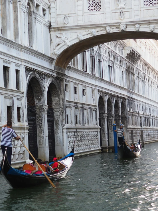 two gondolas and a bridge on a waterway