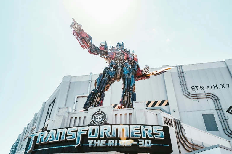 a giant statue of a optting optter is standing next to the words transformrs