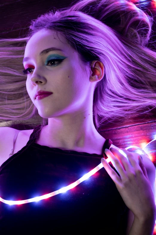 a model with bright led headbands looks at the camera