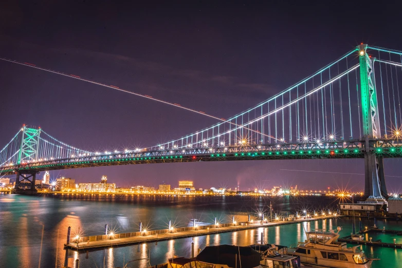 a large bridge over a river at night