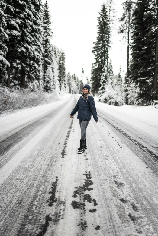 a person riding a skateboard on a snowy road