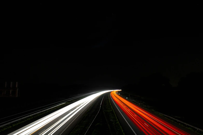 the light from cars streaking by the side of the road