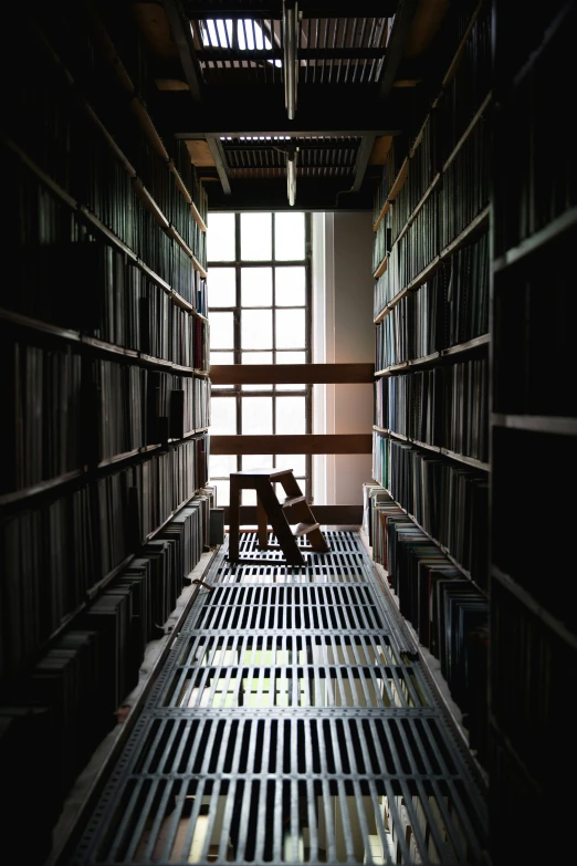 a man sitting in a chair near bookshelves