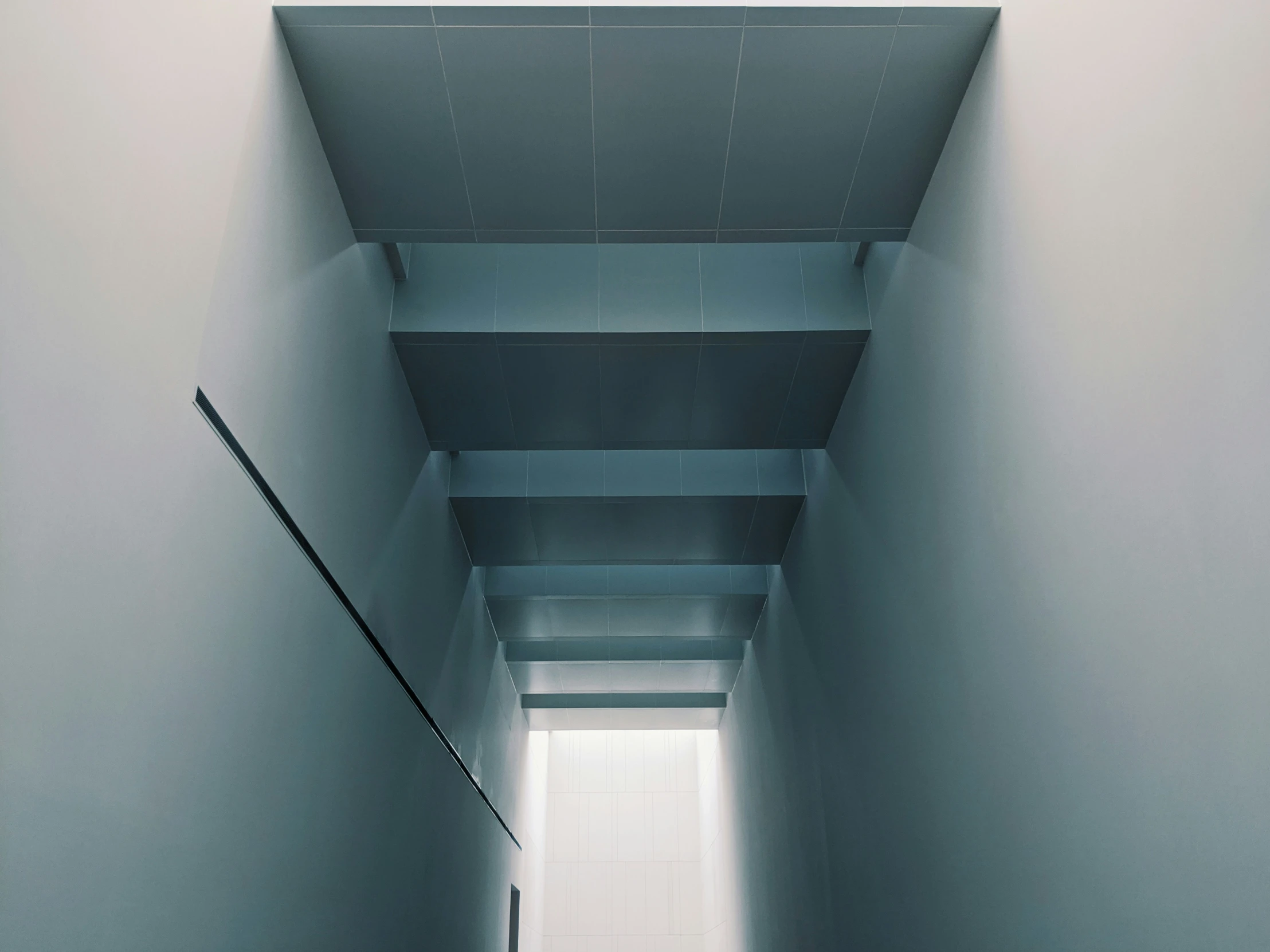 the walls and floor of an empty white room are