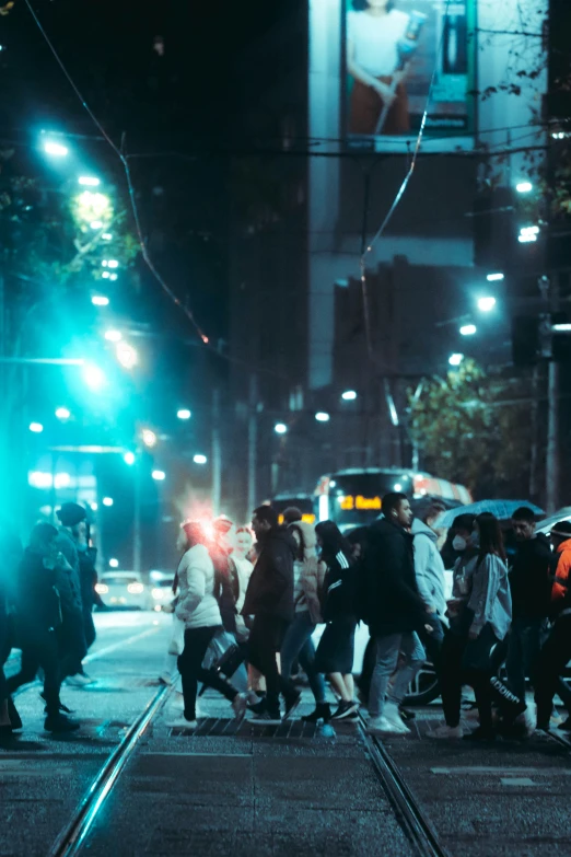 the people are crossing the street in the rain