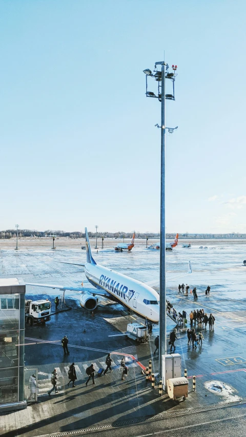 passengers get ready to board an airliner in the ice