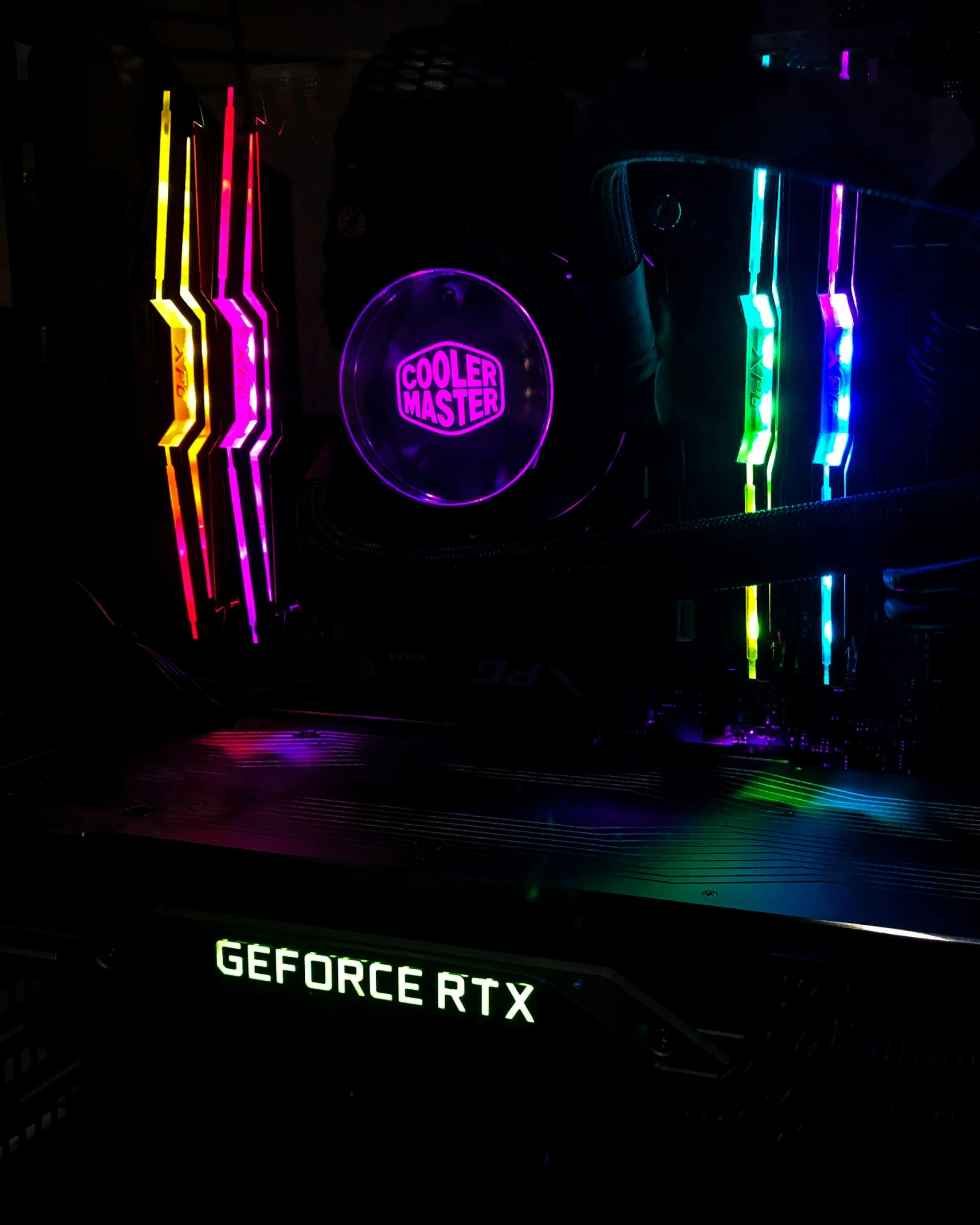 a computer with neon lights and a logo