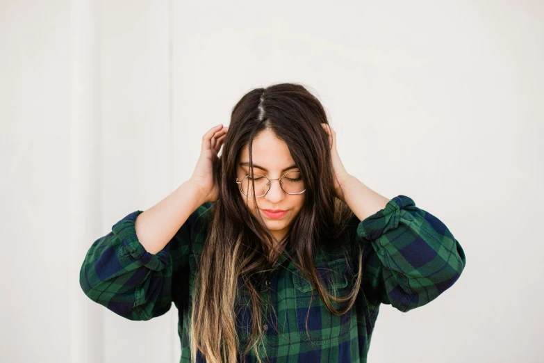 the woman is wearing glasses and has her hair tied back