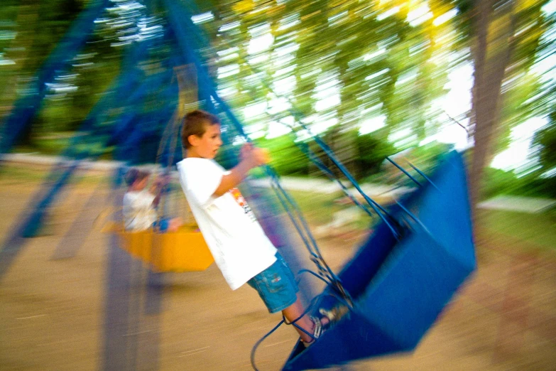 a child swinging on a swing at the park