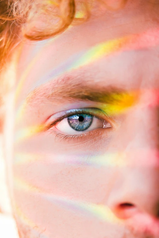 a man with colored hair and blue eyes