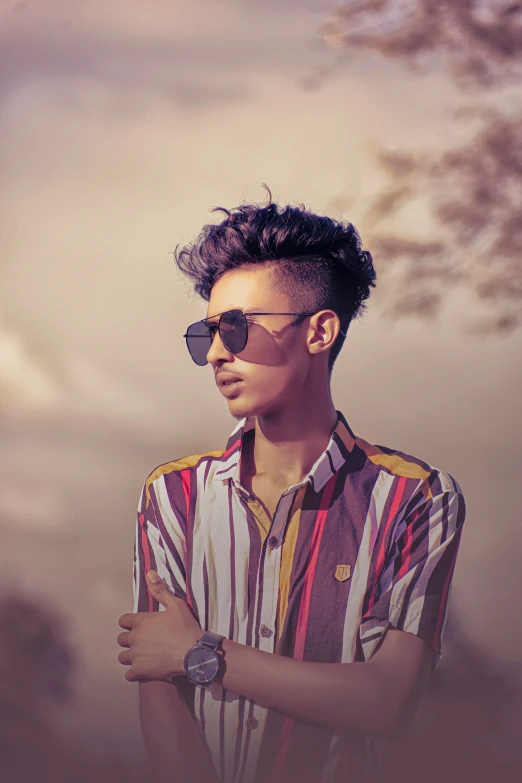 a person wearing glasses standing next to a palm tree