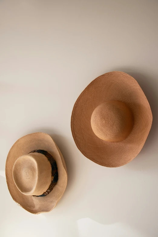 two hats sitting on top of each other on the ground