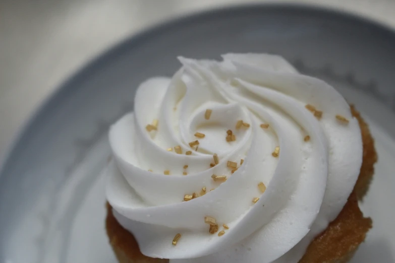 there is a cupcake topped with white icing