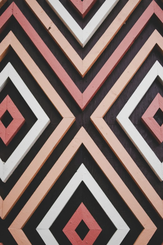 a black red and white pattern is in an area with pink tiles