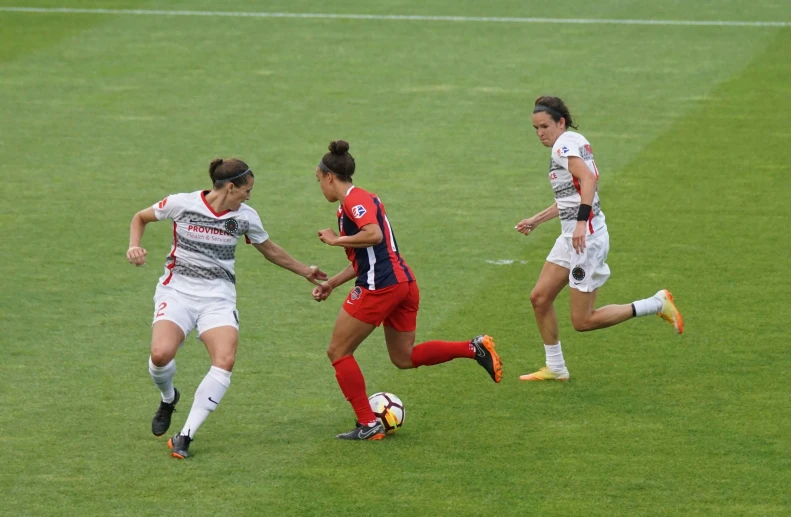 a couple of girls that are playing soccer