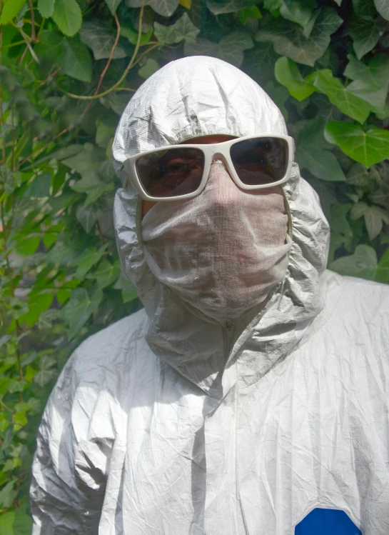 a white protective man wearing goggles and a jacket