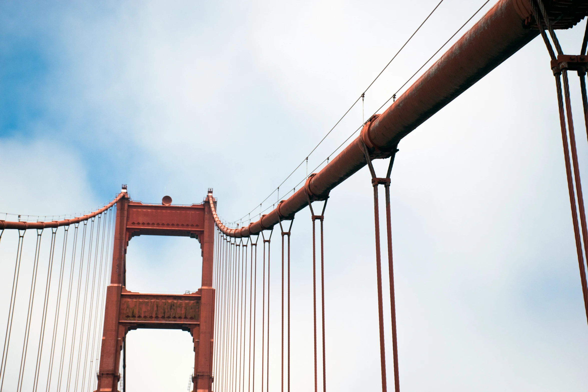 a suspension of the golden gate bridge, seen from below