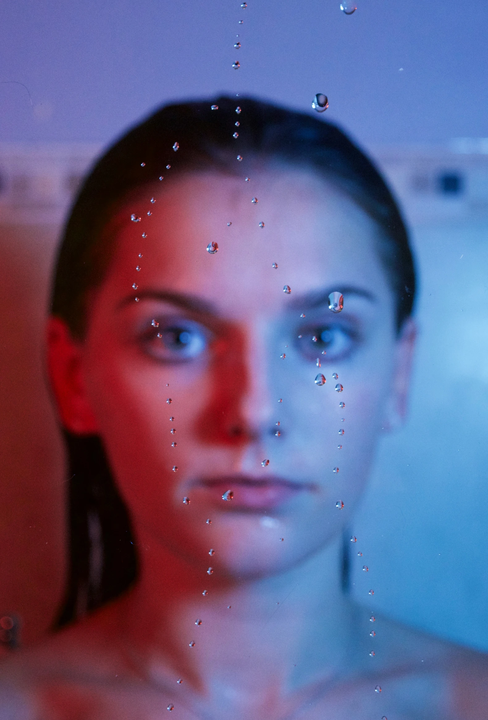 a woman in the tub with some water running down her face