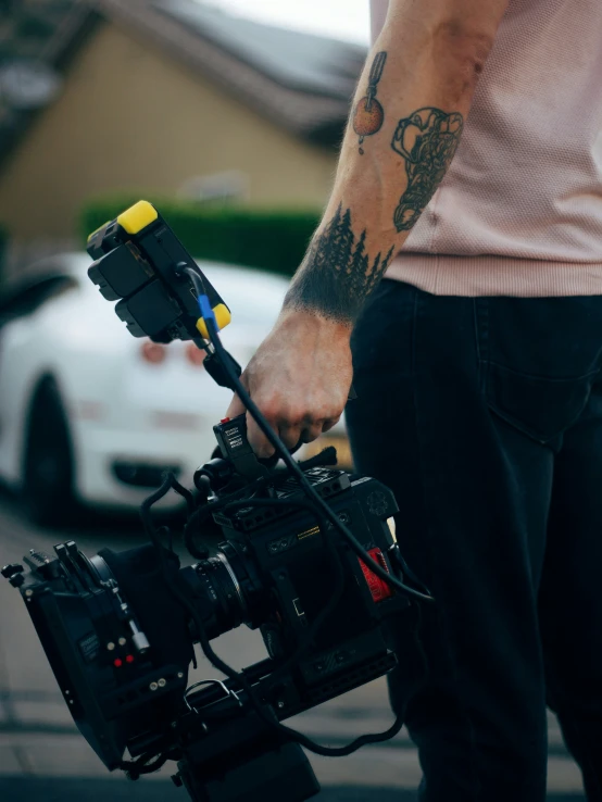 a camera operator holding a film camera in his hand