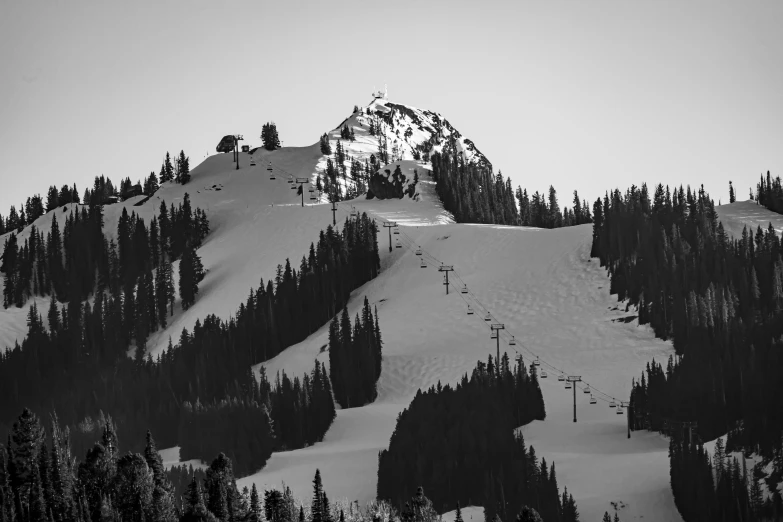 black and white po of a snowboarder coming down a mountain