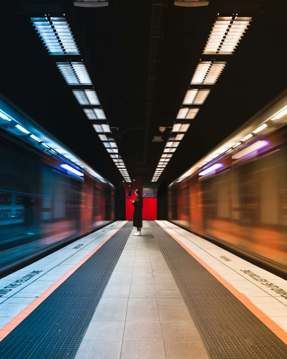 there is a woman that is waiting for the train