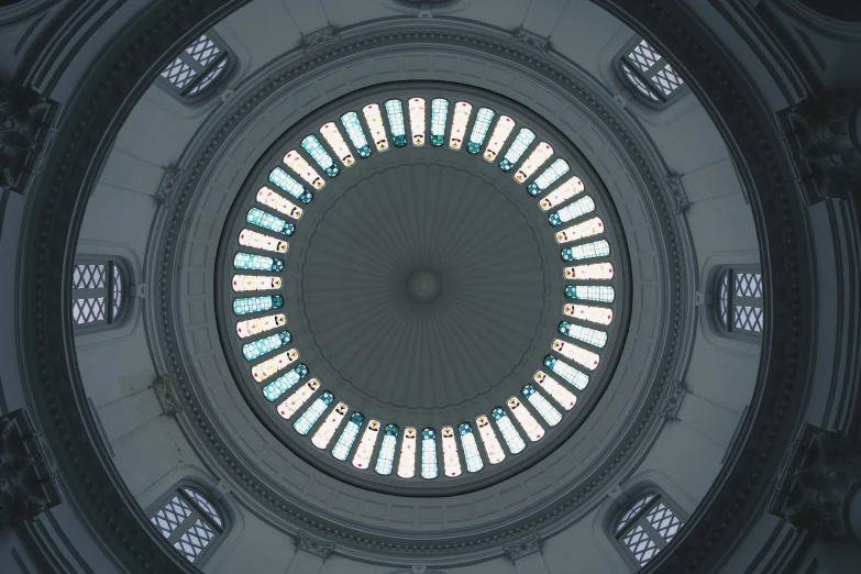 looking up at the circular stained glass ceiling