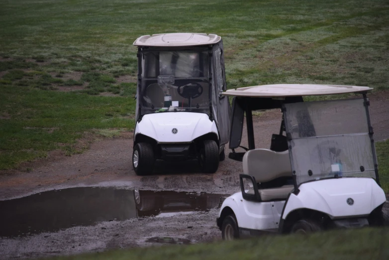 a golf cart and cart behind some golf carts