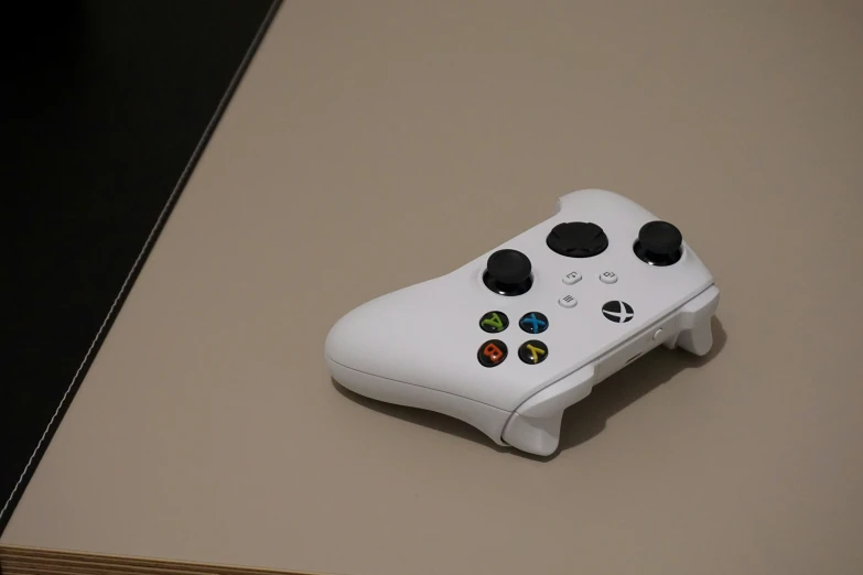 a white controller with four on ons sitting on top of a table