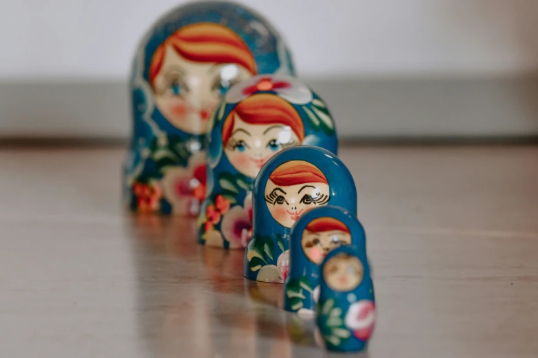 a set of three painted dolls on a table