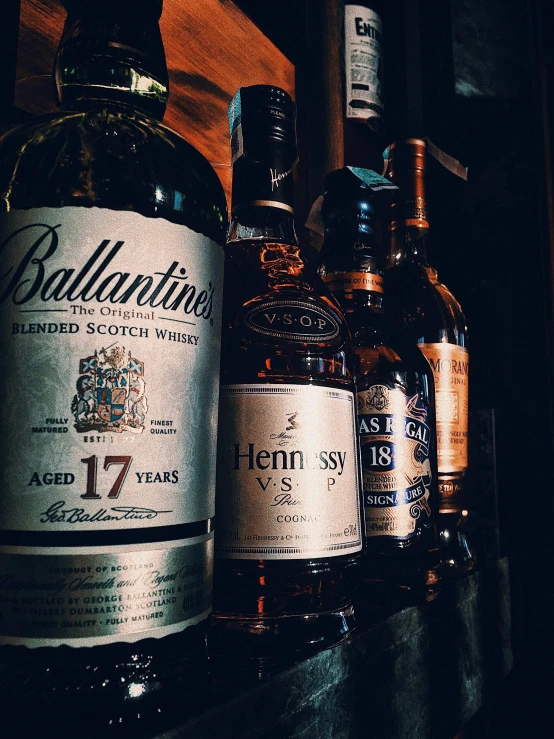 several bottles sitting on top of a wooden shelf