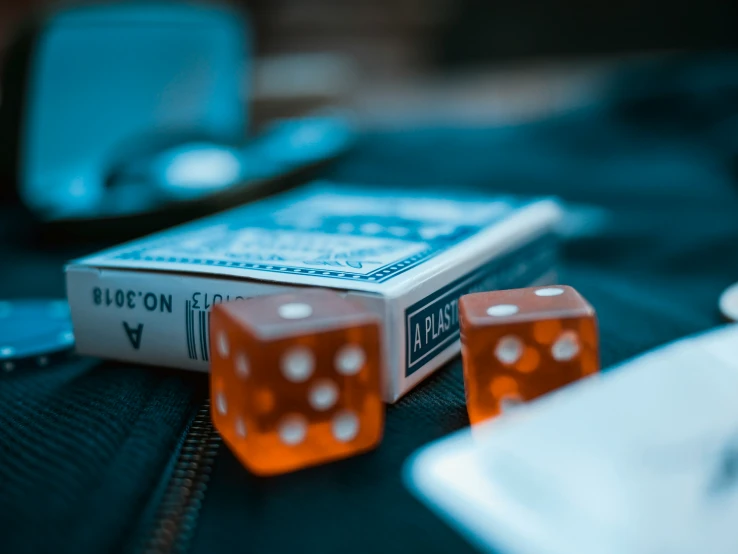 two red dices are on a black cloth