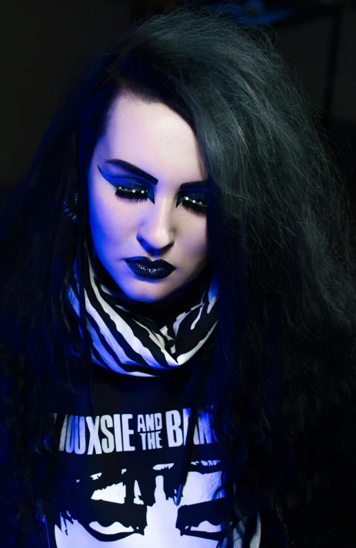 a close up s of a female wearing dark makeup