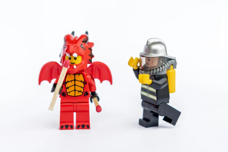 two lego knights, one with a helmet and a dragon, both wearing armor