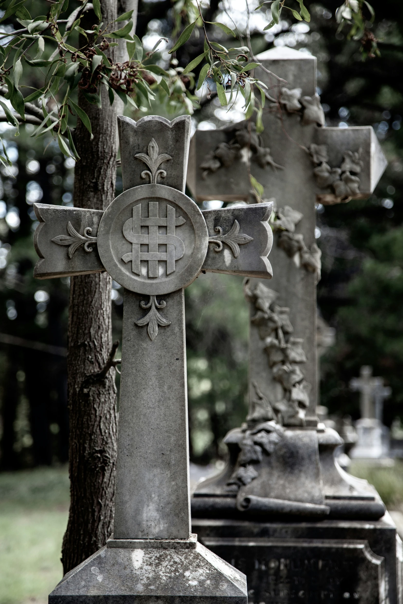 two very old crosses in a grave yard