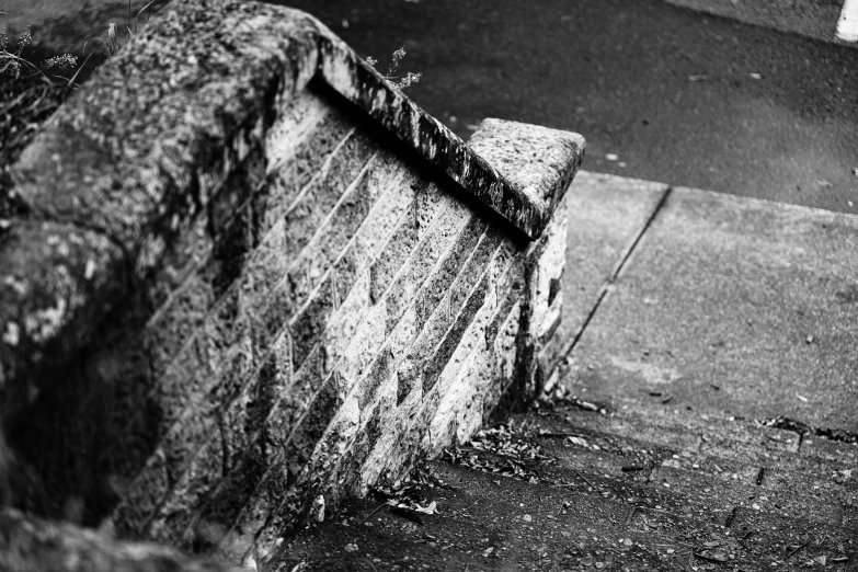 an old bench sitting beside a sidewalk on the side of a street