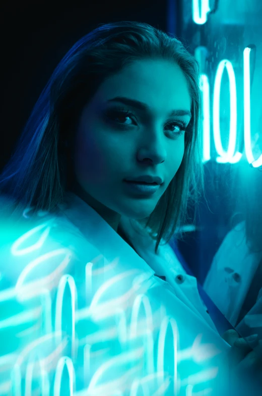 a woman is sitting by the wall in a neon room