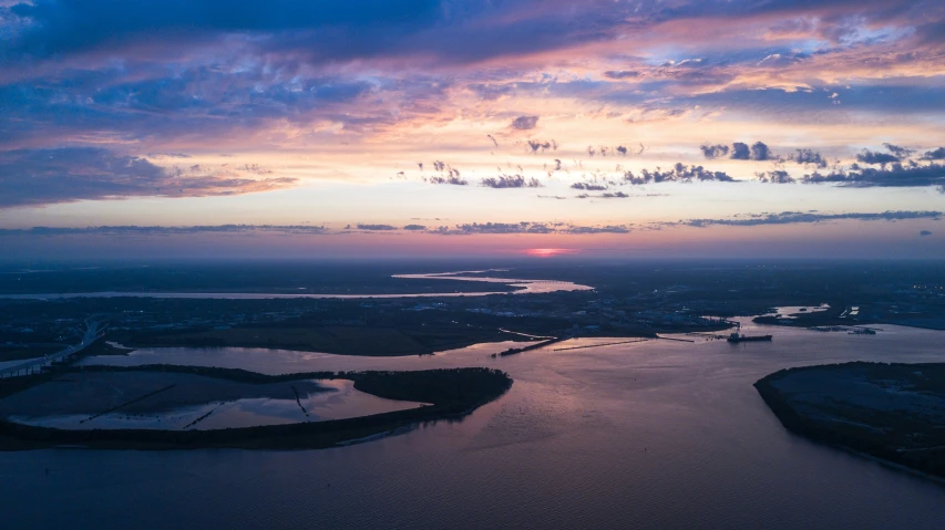 a very nice view of a river and the sun