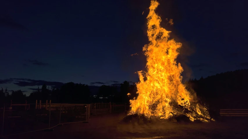 a large bonfire on the ground lit up in the dark