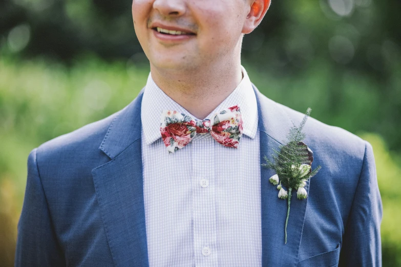 a man is wearing a suit and bow tie