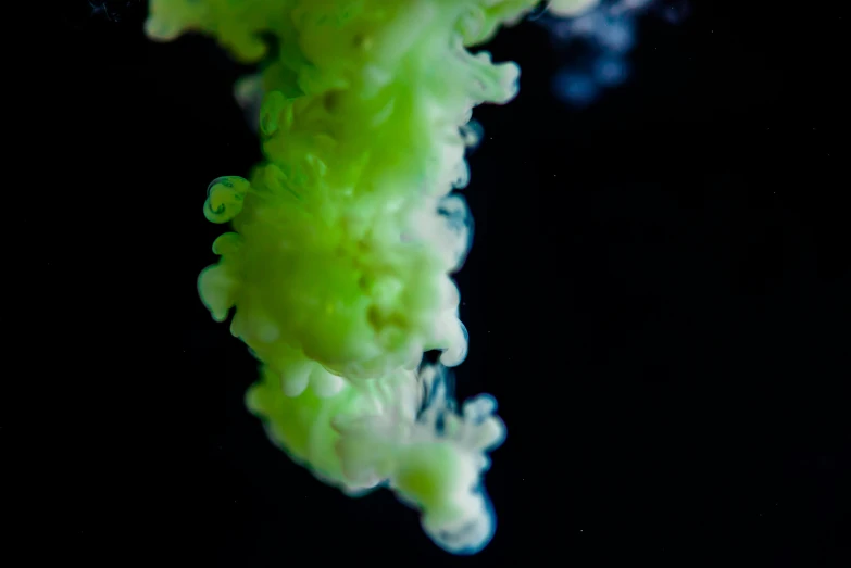 a dark background with some green liquid