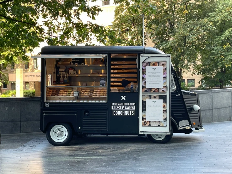 a small food cart sitting on the side of the street