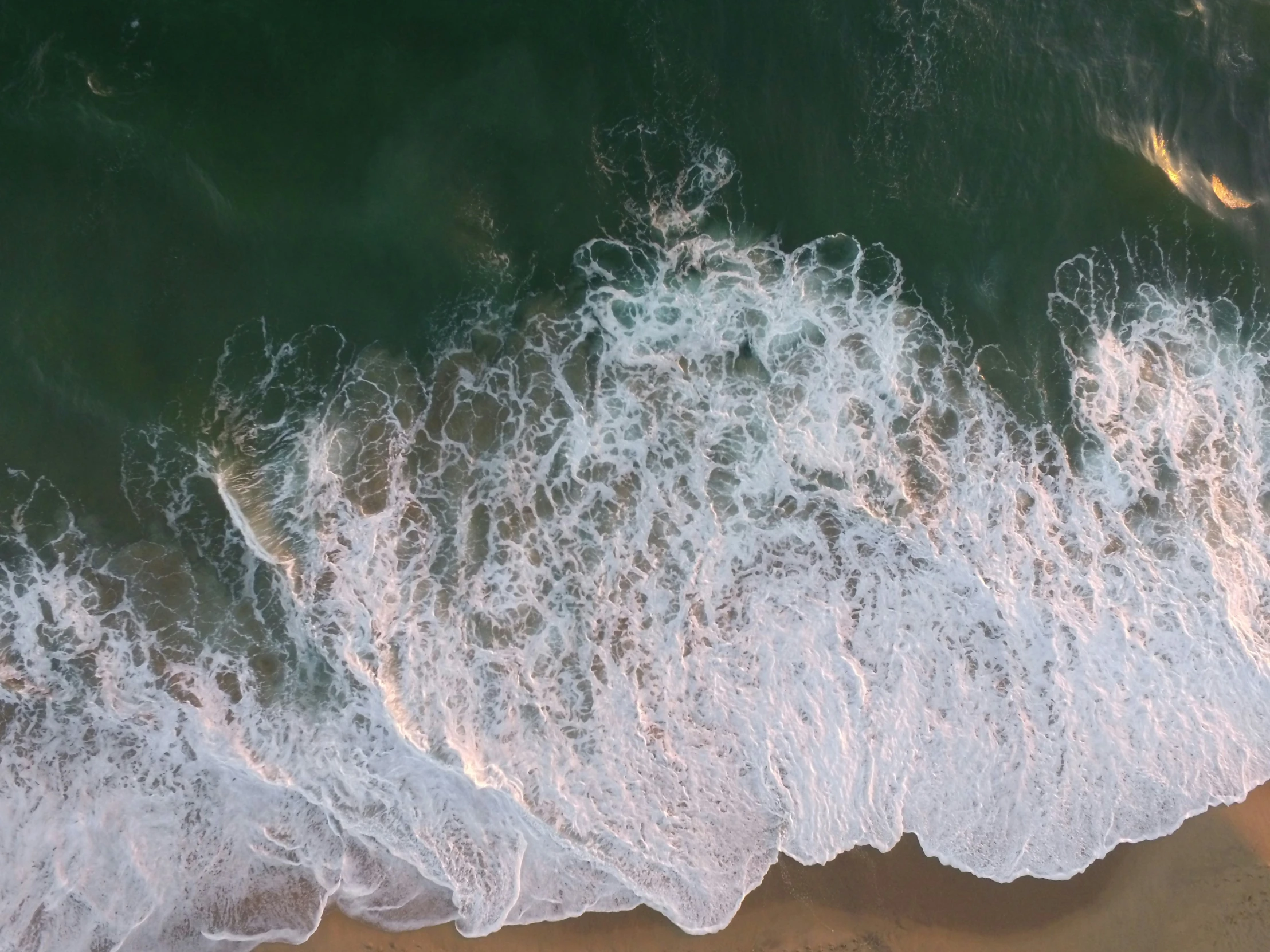 a beautiful beach scene with waves rolling into the shore