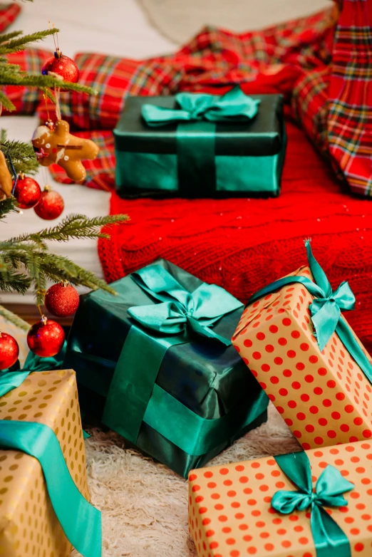 presents that are sitting under a small christmas tree