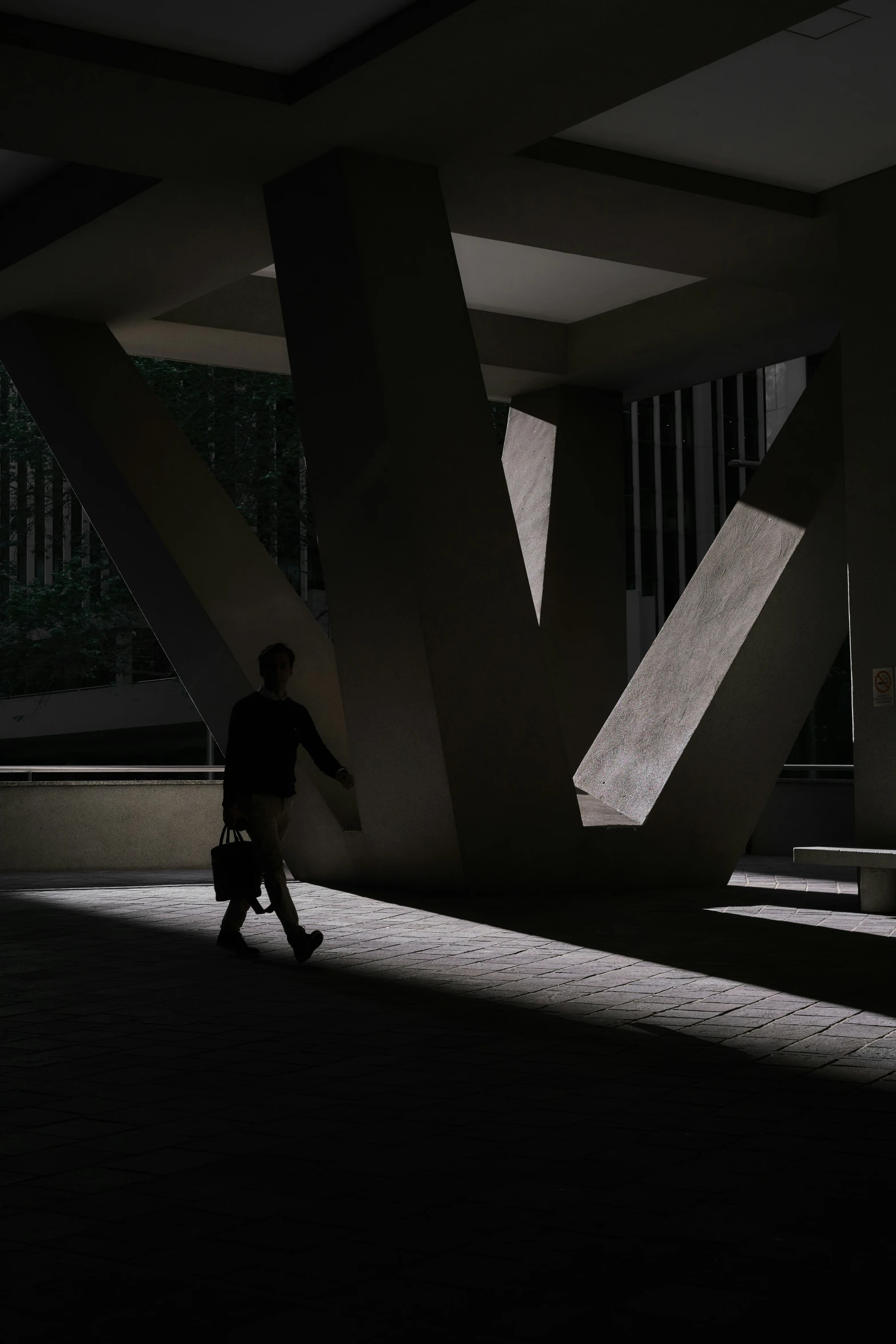 a man walking through the tunnel in a building