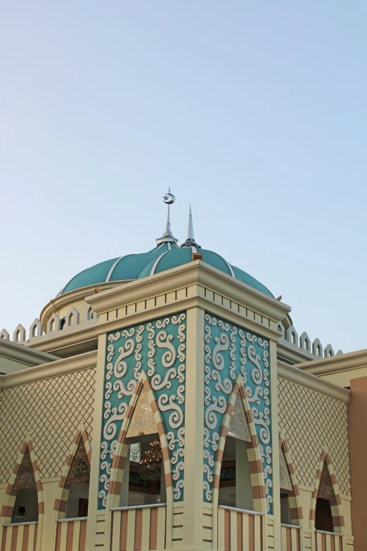 a tall blue and white building with clocks on top of it