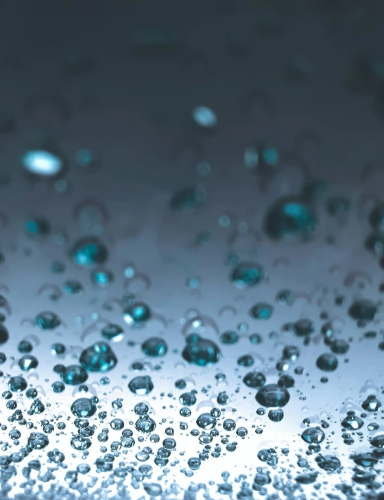 water drops are shown in front of a dark background