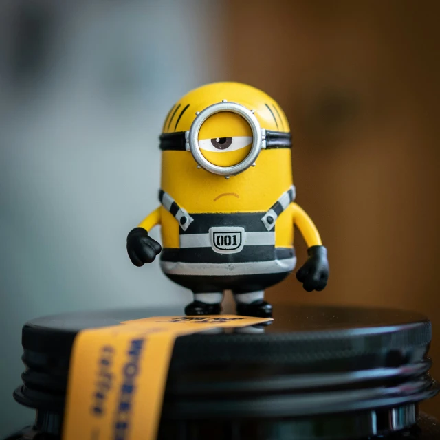 a close up of a toy minion sitting on top of a table