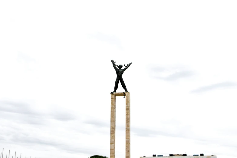 a man on a high platform holds his hands in the air